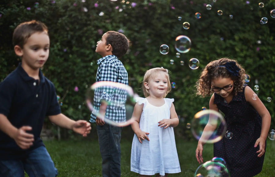 Kids playing outside with bubbles
